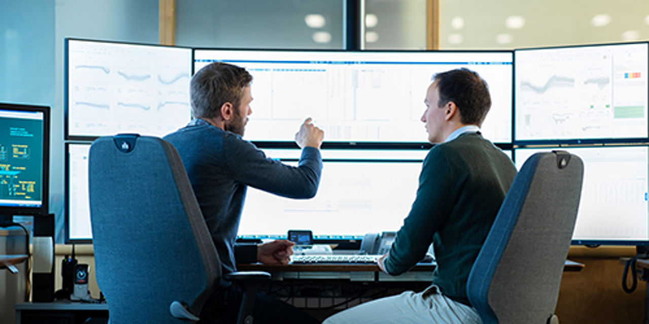 Men working on monitor